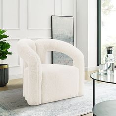 a white chair sitting on top of a rug in a living room