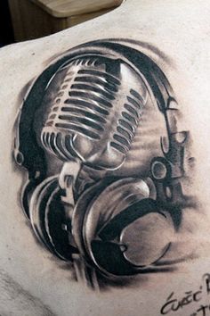 a man with a microphone and headphones tattoo on his back