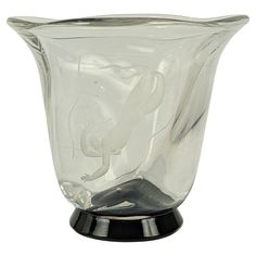 a glass vase sitting on top of a metal stand