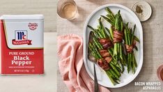 bacon wrapped asparagus on a plate next to a can of ground black pepper