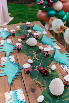 a wooden table topped with lots of paper decorations