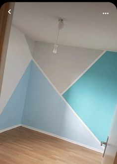 an empty room with blue and white walls