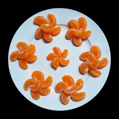 peeled oranges arranged on a white plate