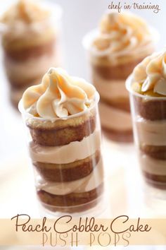 four desserts with frosting and icing in small glass cups on a table