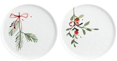 two white plates decorated with holly and berries