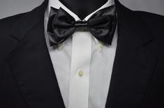 Our rendition of the classic black bow tie. Handcrafted Satin 5 x 2.75 inches with adjustable neck band of  twenty inches. Can be worn, anywhere, anytime, any place, you decide. Classic Adjustable Bow With Detachable Feature, Elegant Black Tuxedo For Black Tie, Elegant Black Suit And Tie Accessories For Evening, Classic Bow Tie For Black-tie Events, Classic Black Bow Tie And Accessories, Classic Black Bow Tie And Suit Accessories, Classic Adjustable Bow Tie For Black-tie Events, Classic Black Bow Tie Suit Accessories, Black Dapper Bow Tie Accessories