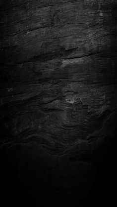 black and white photograph of wood textured with dark lighting from the top right corner