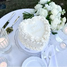 a white wedding cake sitting on top of a table