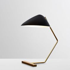 a black and gold lamp sitting on top of a table