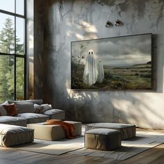 a living room filled with furniture and a painting hanging on the wall above it's windows