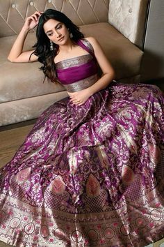 Indulge in the elegance of this stunning purple Banarasi lehenga adorned with intricate golden zari work. The rich silk fabric and elaborate patterns create a royal aura, perfect for weddings, festive celebrations, or special occasions. Elevate your traditional style with this exquisite ensemble that blends heritage with luxury.  Hashtags:  #BanarasiLehenga #PurpleLehenga #IndianFashion #TraditionalAttire #WeddingWear #FestiveFashion #ZariWork #EthnicWear #BridalOutfit #LehengaLove Purple Pattu Lehenga, Lehenga Designs Saree, Saree Pattern Dress, Lehenga Out Of Saree, Purple Ethnic Wear Women, Corset Traditional Dress, Corset Style Blouse, Blouse Designs With Lehenga, Silk Saree Dress Design Ideas