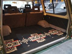 the interior of a vehicle with an area rug on the floor in front of it