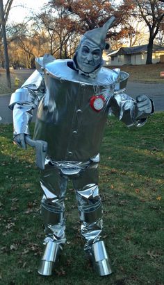 a man dressed up as a tin man in the grass