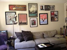 a living room filled with furniture and pictures on the wall