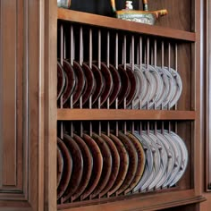 a wooden book shelf filled with lots of plates