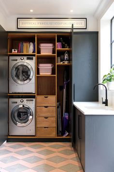 a washer and dryer in a small room next to a counter with drawers