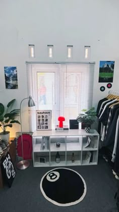 a room that has some clothes hanging on the wall and a rug in front of it