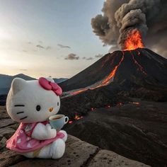 a hello kitty doll sitting in front of a volcano