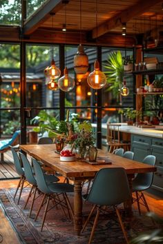 a wooden table surrounded by blue chairs in a room filled with plants and hanging lights