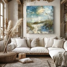 a living room filled with white furniture and paintings on the wall above it's windows