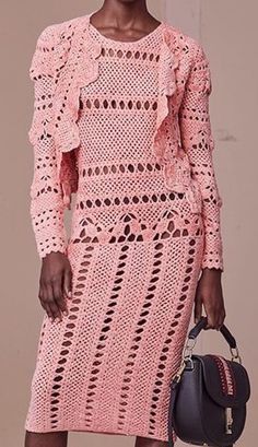 a woman in a pink crochet dress