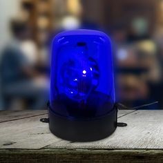 a blue light sitting on top of a wooden table