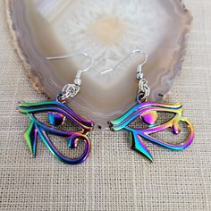 Eye of Ra Earrings, Iridescent Titanium Rainbow Plated, Dangle Drop Earrings, Egyptian Jewelry * Moderately weighty earrings. * French earwires that are lead and nickel free. * Ships is a gorgeous box ready for gift giving. * To lengthen the life of your jewelry, do not shower or bathe with it on. * Your item will ship between 1-2 business days. * Priority Shipping is available at checkout. Iridescent Pierced Drop Earrings, Iridescent Pierced Earrings As Gift, Rainbow Dangle Metal Earrings, Hypoallergenic Rainbow Colored Metal Jewelry, Hypoallergenic Rainbow Metal Jewelry, Rainbow Metal Earrings With Ear Wire, Nickel-free Rainbow Drop Earrings, Multicolor Metal Jewelry With Ear Wire, Rainbow Nickel-free Drop Earrings