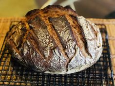 a loaf of bread sitting on top of a cooling rack