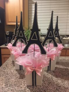 the eiffel tower is made out of cardboard and pink bows on top of each other