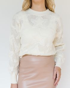 This skirt is an elegant, high-waisted, pencil-style midi skirt that extends down to the mid-calf, offering a refined and sophisticated look. It is crafted from a faux leather material, which gives it a sleek and polished appearance, with a subtle shine that catches the light. The skirt comes in a soft beige or nude color, making it a versatile piece that can be paired with a variety of tops and accessories. The material appears structured yet flexible, providing both comfort and a body-hugging fit that accentuates the wearer's silhouette. The back of the skirt features a center slit, strategically placed for functionality and ease of movement, while maintaining the classic pencil skirt shape. This design choice adds an element of practicality without compromising the streamlined aesthetic Fall Beige Pencil Mini Skirt, Chic Winter Knee-length Mini Skirt, Chic Winter Midi-length Pencil Skirt, Winter Chic Midi-length Pencil Skirt, Chic Fall Midi Pencil Skirt, Chic Knee-length Winter Mini Skirt, Chic Knee-length Mini Skirt For Winter, Chic Winter Pencil Skirt, Chic High-waist Winter Pencil Skirt