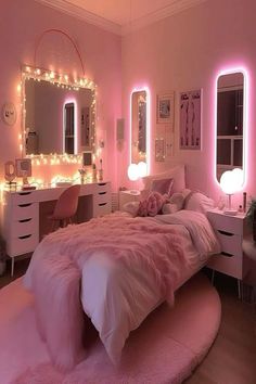 a bedroom decorated in pink and white with lights on the wall, vanity table, mirror and bed