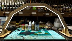 an art studio with various paints and tools on the table, including paintbrushes