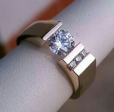 a close up of a ring with a diamond on it