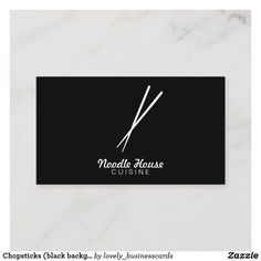 a black business card with white scissors and the words needle house quilting on it