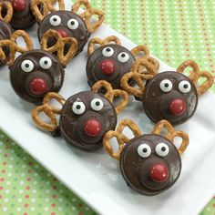 chocolate covered pretzels with eyes and noses on a plate