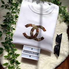 a pair of sunglasses and a t - shirt with the logo of chanel on it