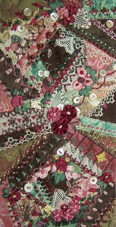 an intricately designed piece of fabric with flowers and laces on it's edges