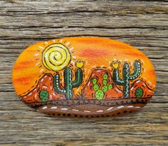 an orange painted rock sitting on top of a wooden table