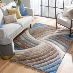 a living room with a couch, chair and rug