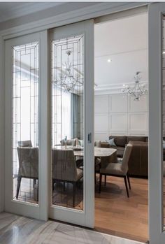 an open glass door leading to a dining room