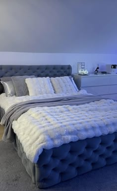 a bed with white fur on it in a bedroom