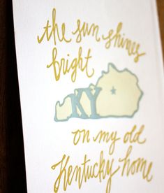 a white card with gold foil on it that says, the sunshine shines bright on my old kentucky home