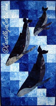 three whales are depicted on a blue and white checkerboard background, with the words ocean winds written in cursive font