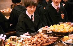 two harry potters are standing in front of a buffet