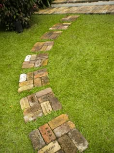 a path made out of bricks in the grass