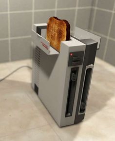 a toaster sitting on top of a counter with a slice of bread sticking out of it