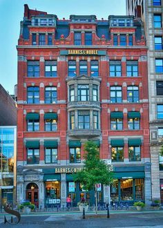 an old brick building with many windows on the front and second story is shown in this photograph