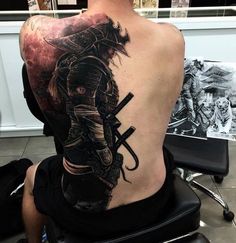 a man with a samurai tattoo on his back