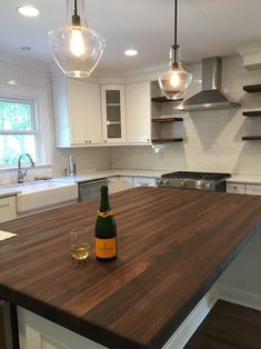 a bottle of wine sitting on top of a wooden counter