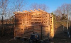 the back end of a truck with wood pallets stacked on it